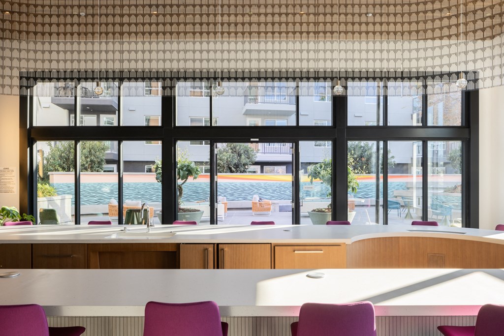 a view of a pool from a restaurant with tables and chairs