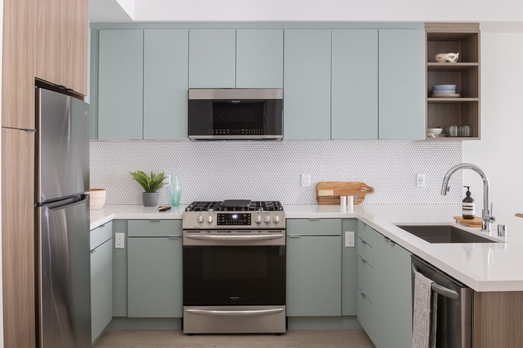 a kitchen with blue cabinets and a sink and a refrigerator