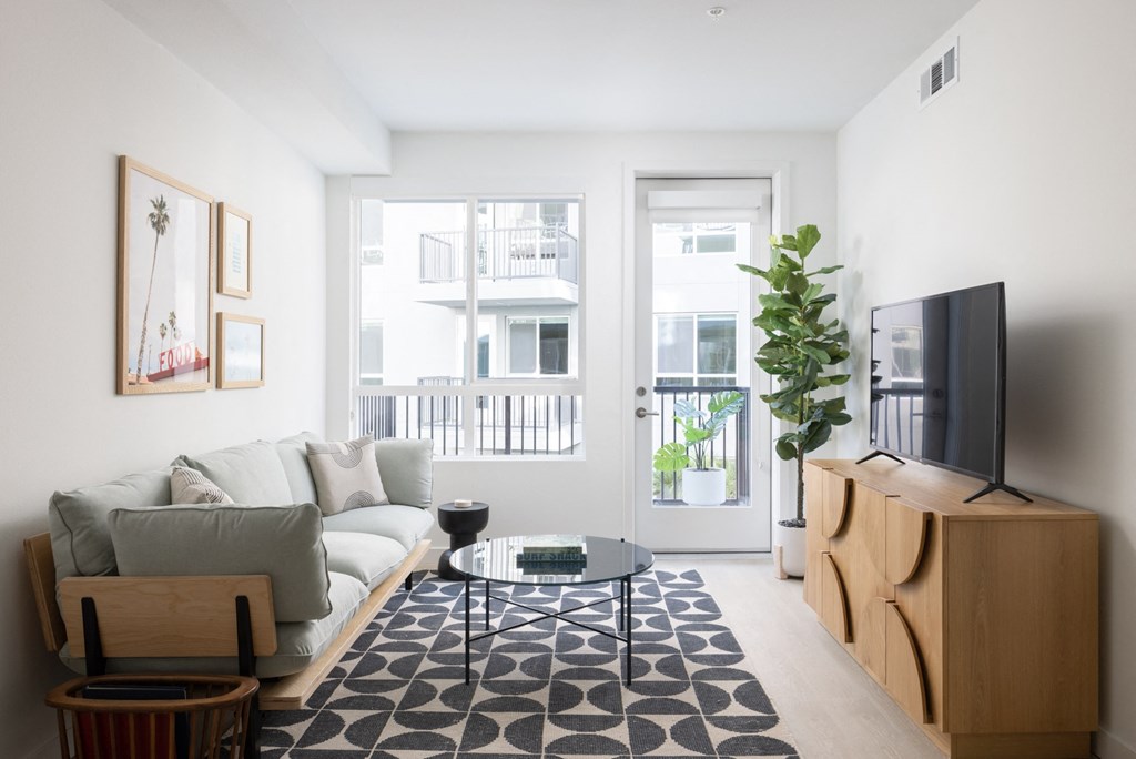 a living room with a couch and a table and a television