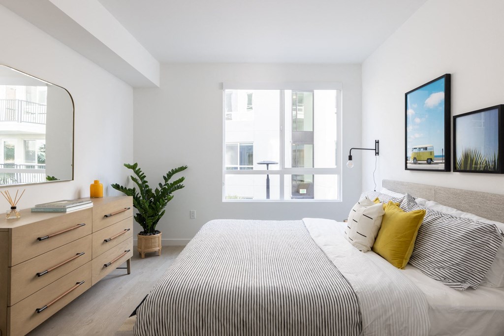 a bedroom with a bed and a large window