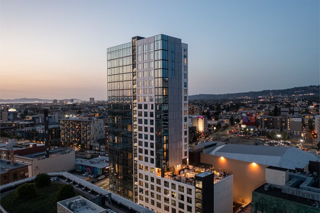 an aerial view of a tall skyscraper in a city at dusk