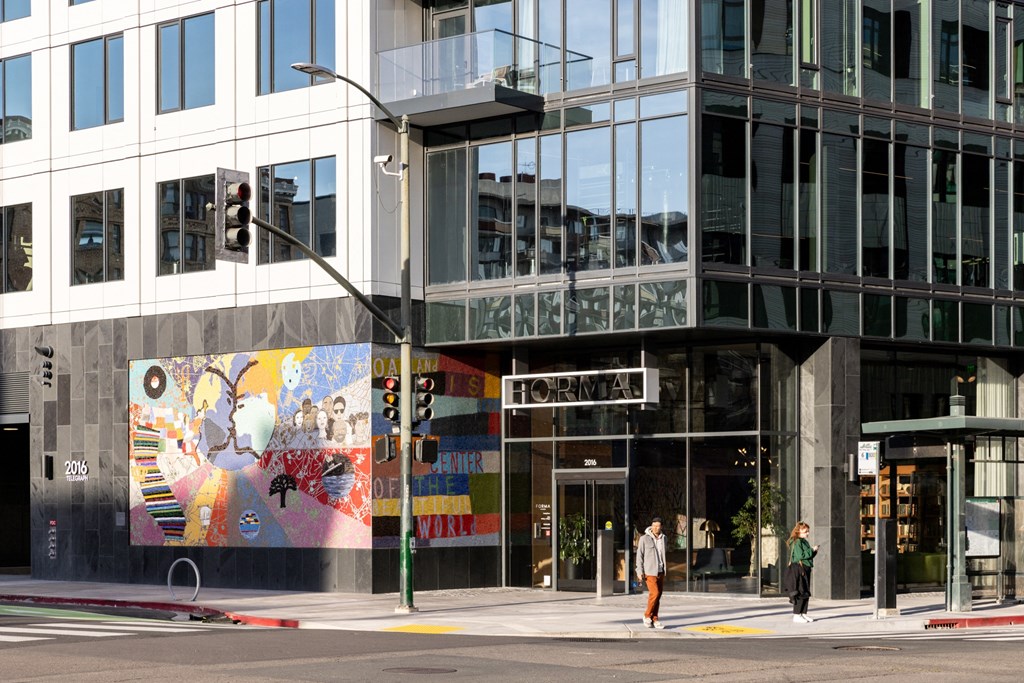 a building with a mural on the side of it on a city street