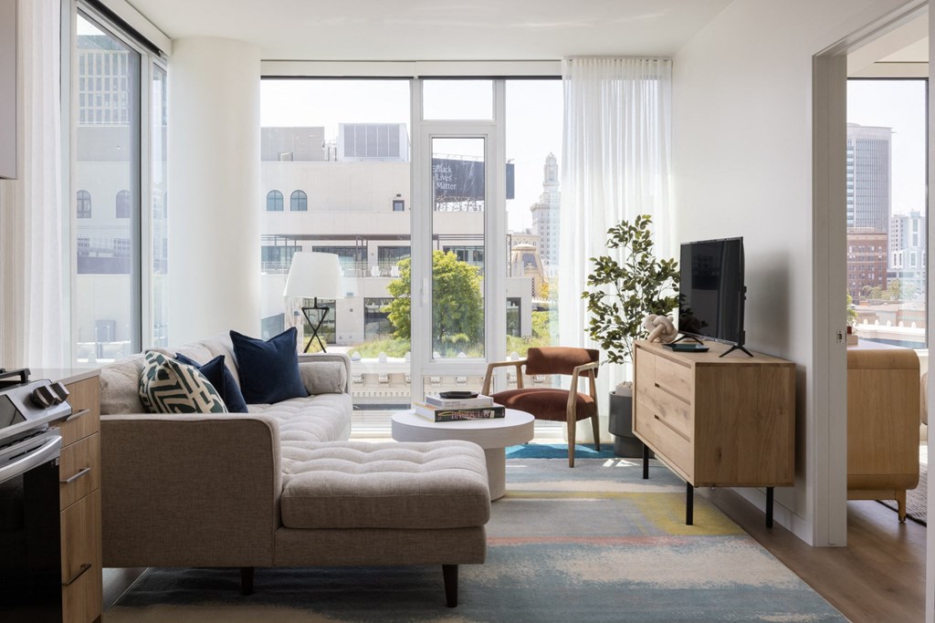 a living room with a couch and a chair and a television
