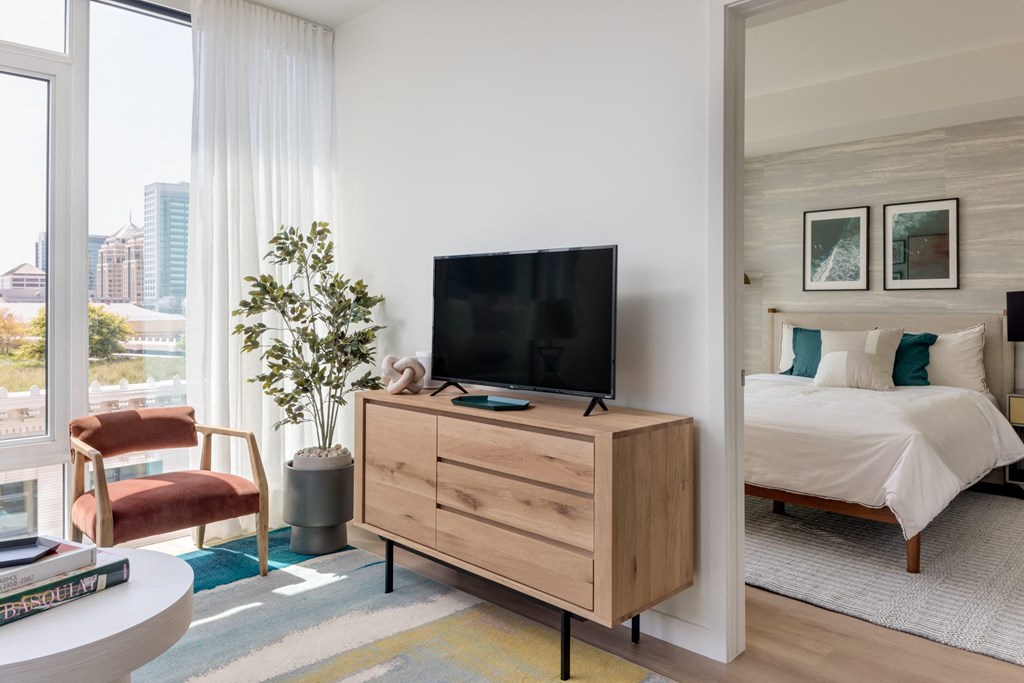 a bedroom with a bed and a tv on a dresser