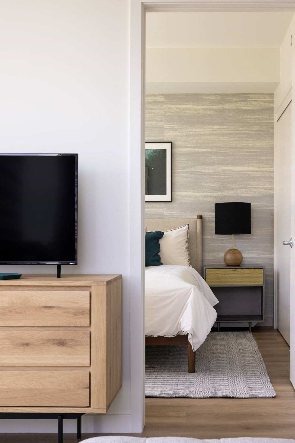 a bedroom with a bed and a television