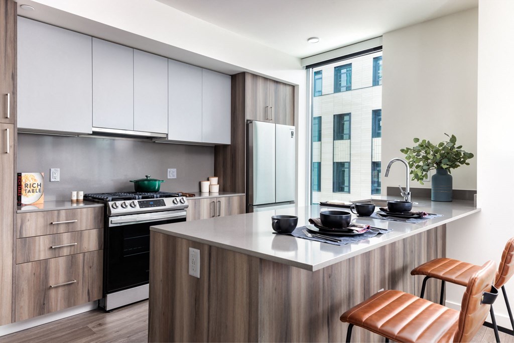 a kitchen with an island and a stove and a window