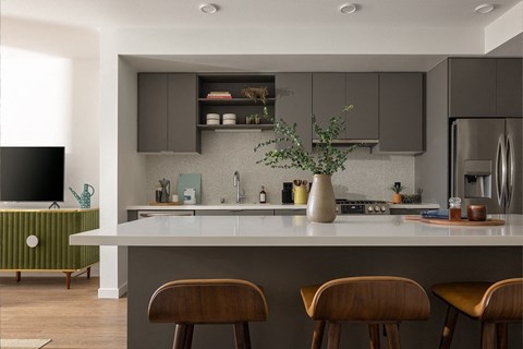 a kitchen with a white counter top and wooden stools