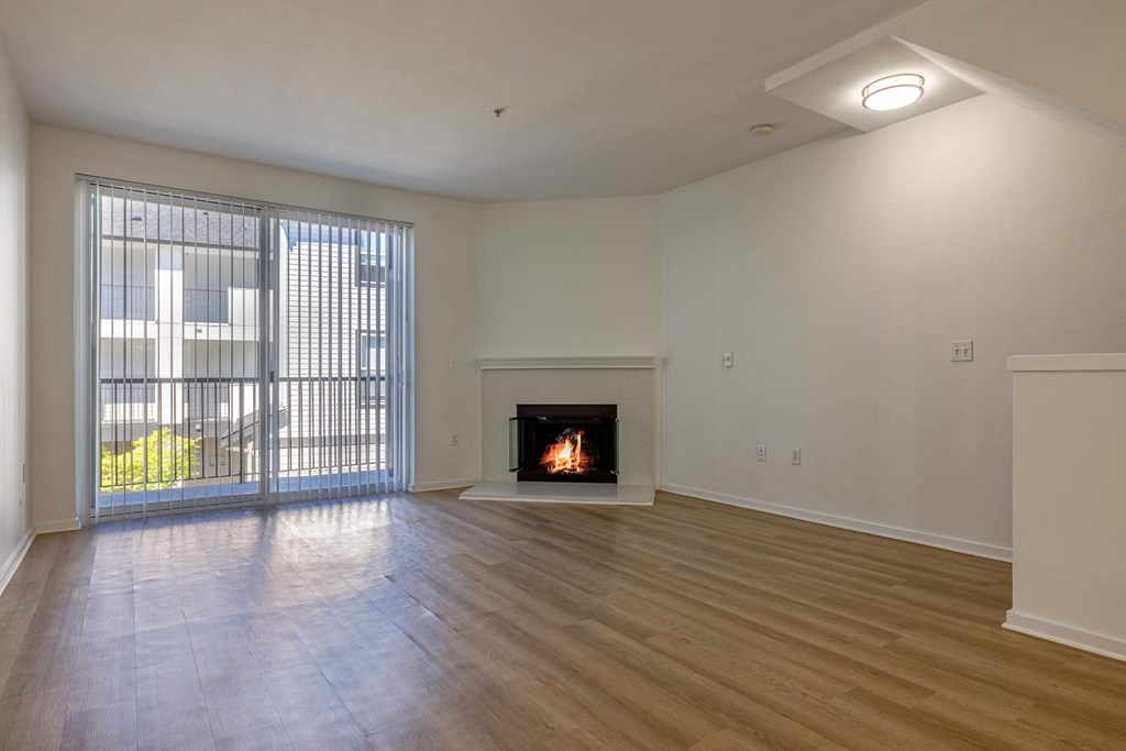 a living room with a fireplace and a balcony