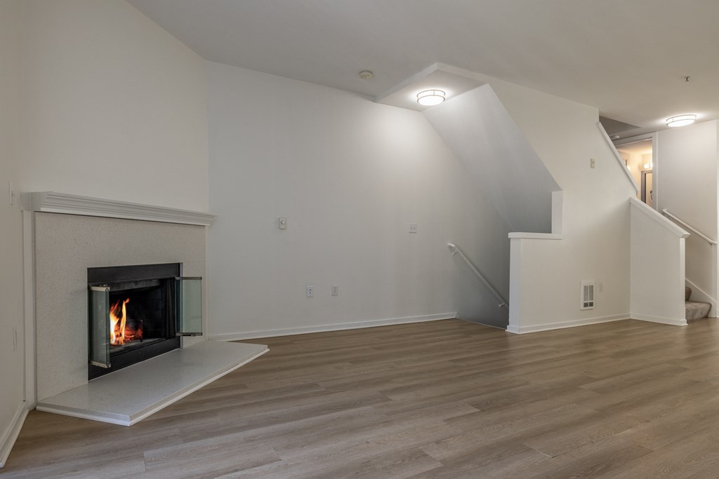 a living room with a fireplace and white walls