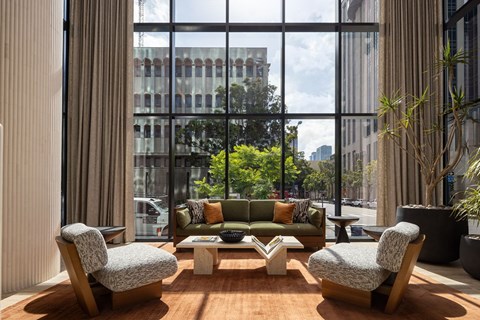 A modern living room with a large window overlooking the city.