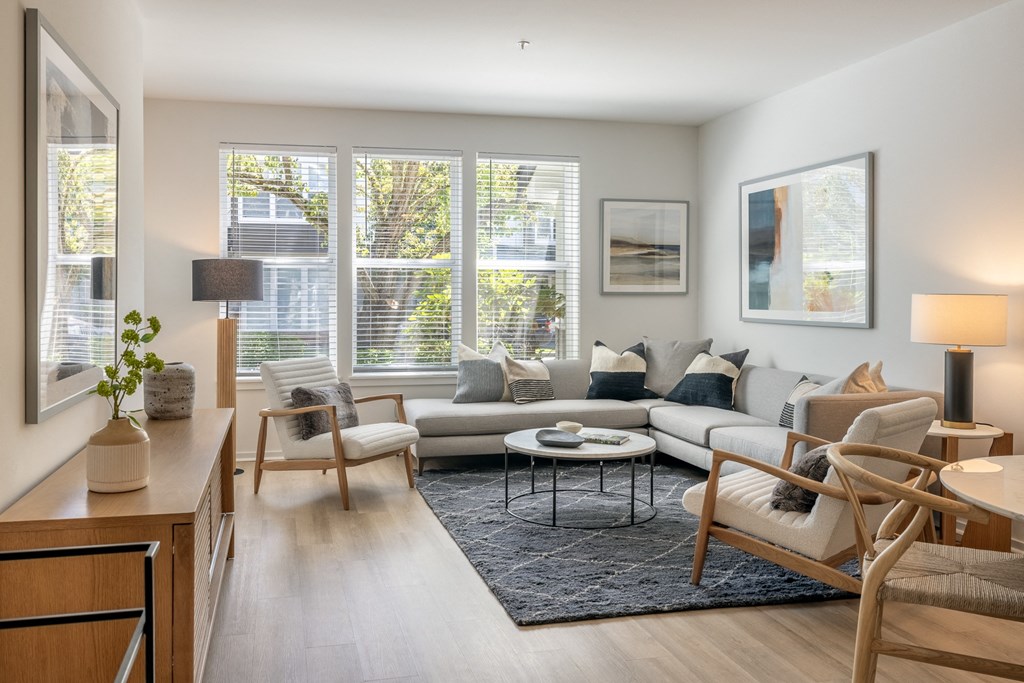 a living room with white walls and hardwood floors