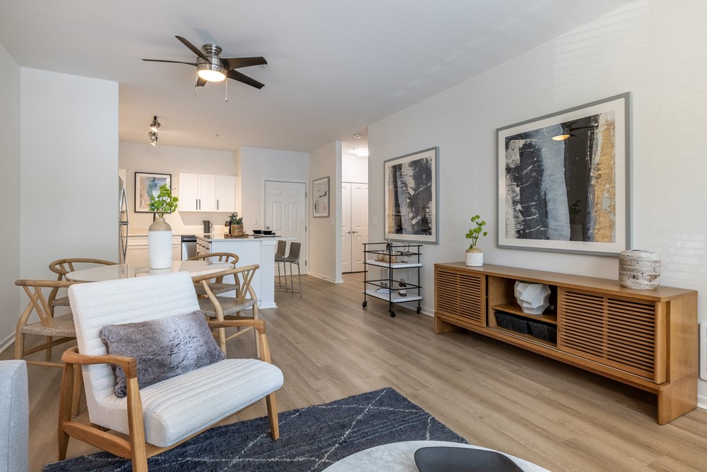 a living room and dining room with hardwood floors and a ceiling fan