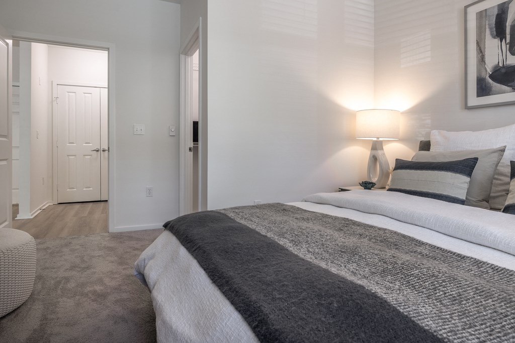 a bedroom with a bed and a chair in a 555 waverly unit