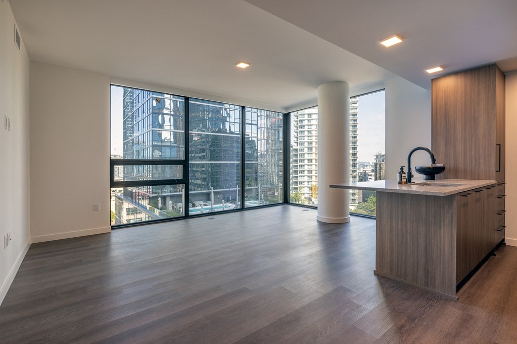 a kitchen and living room with a large window and a city view