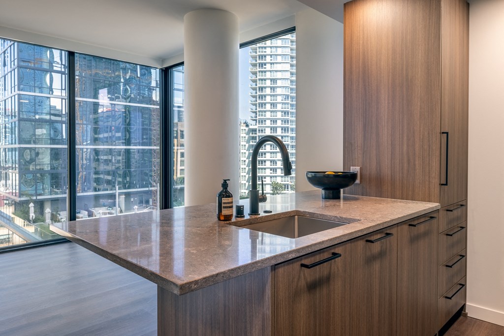 a kitchen with a large window and a large sink