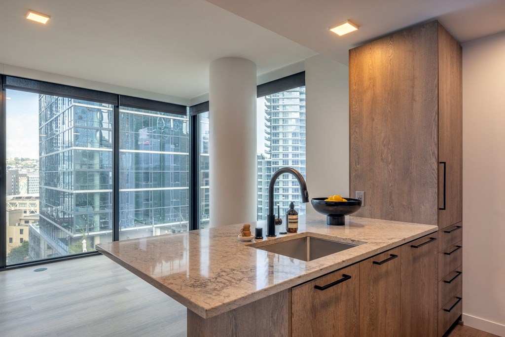 a kitchen with a large window and a sink