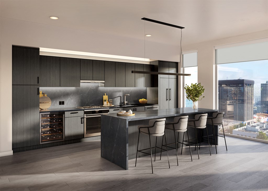 a kitchen with a large island and a table with chairs