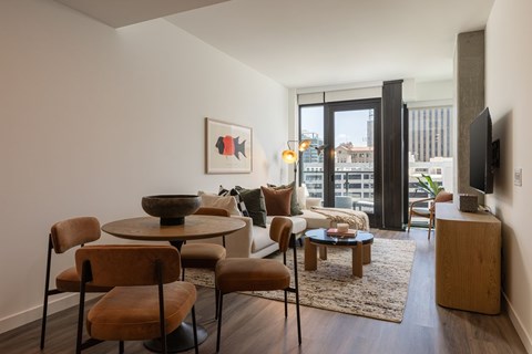 A living room with a table and chairs.
