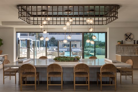A modern dining room with a large table and chairs.