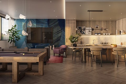 A modern living room with a pool table and a kitchen area.
