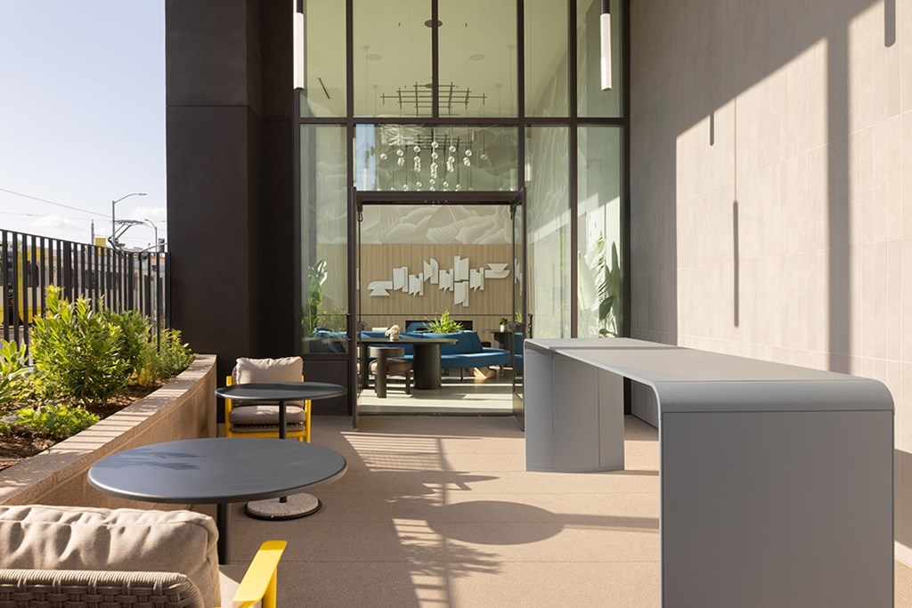 A modern outdoor seating area with a table and chairs.