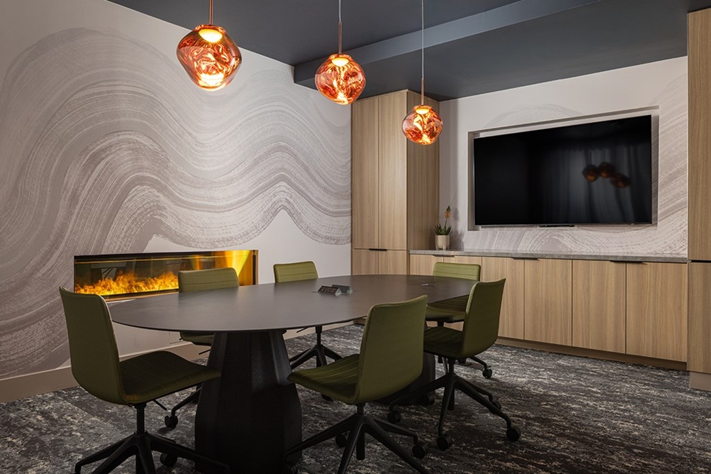 A modern dining room with a round table and chairs.