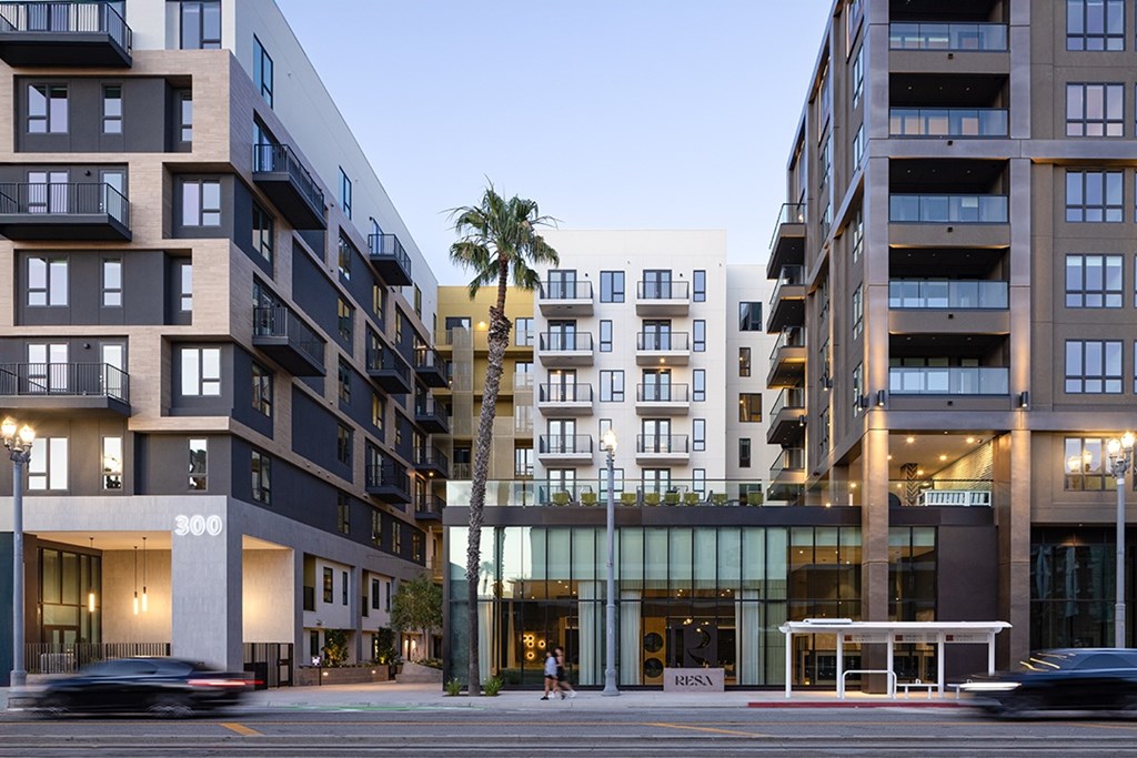 A modern building with a palm tree in front of it.