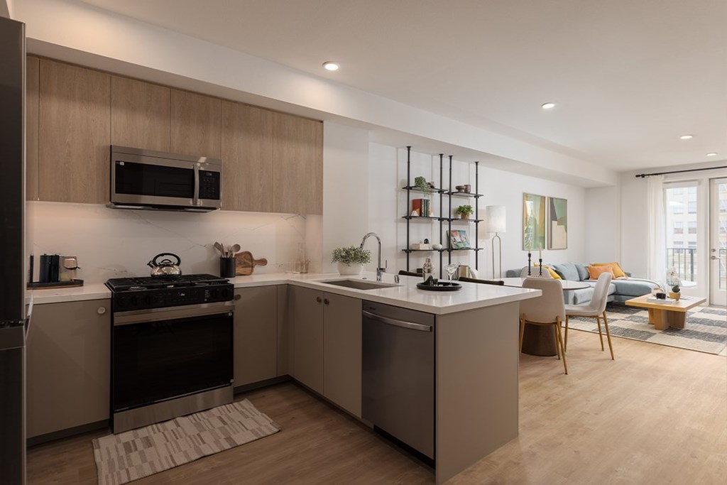 A modern kitchen with a stove top oven and a microwave above the stove.