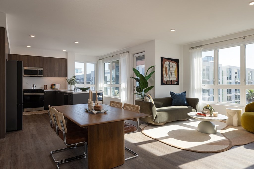 A modern kitchen with a dining table and chairs.