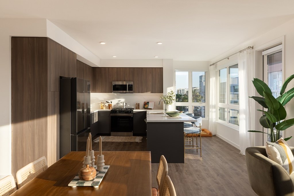 A modern kitchen with a dining table and chairs.