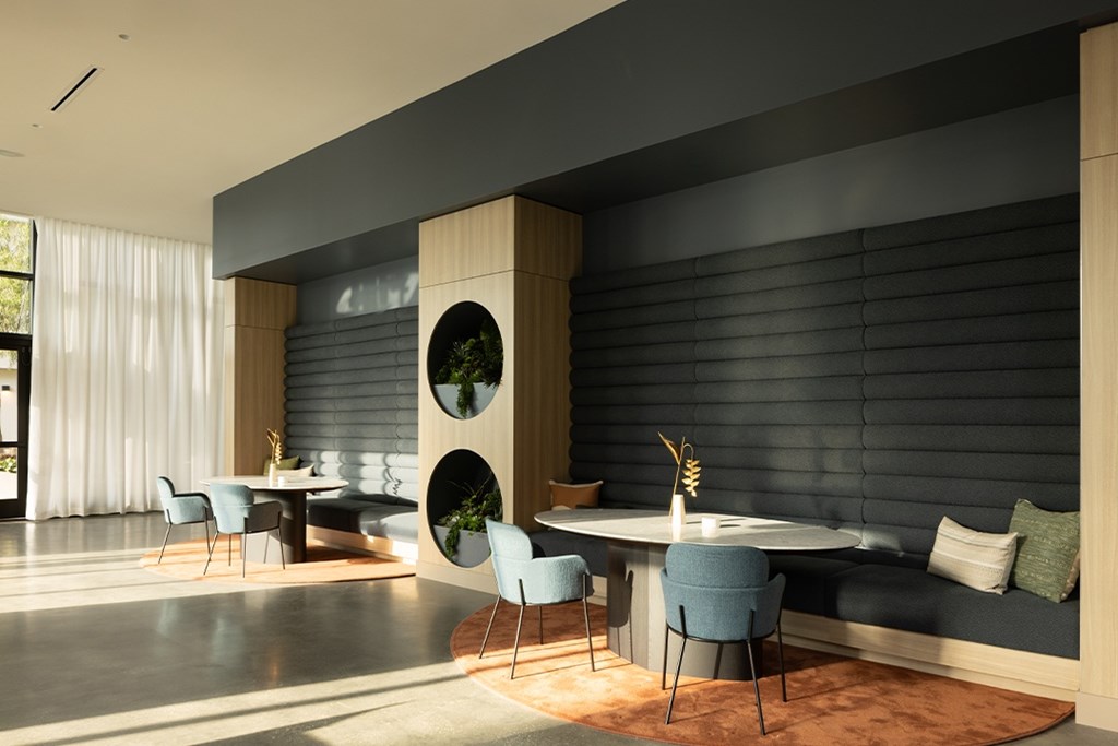 A modern dining area with a round table and chairs.