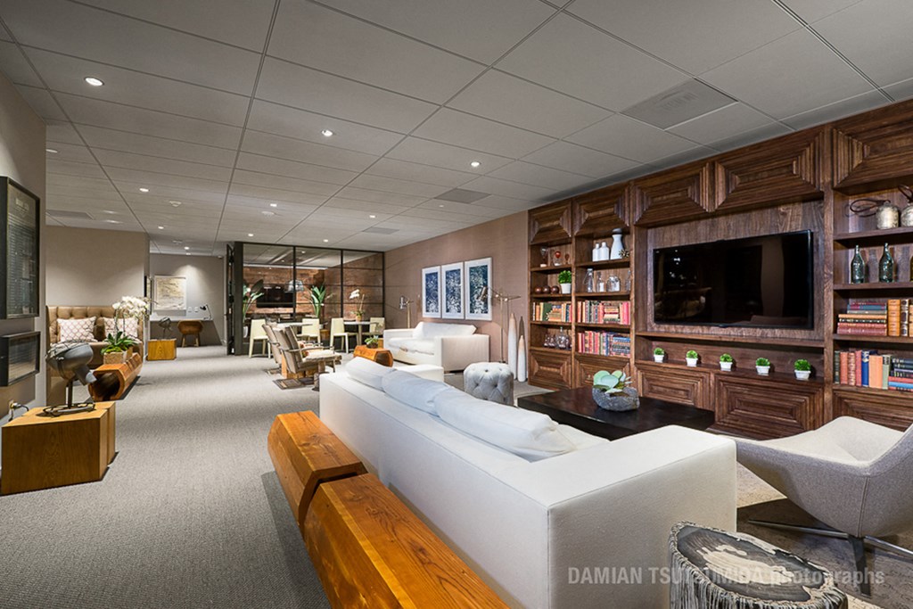 a living room filled with furniture and a flat screen tv
