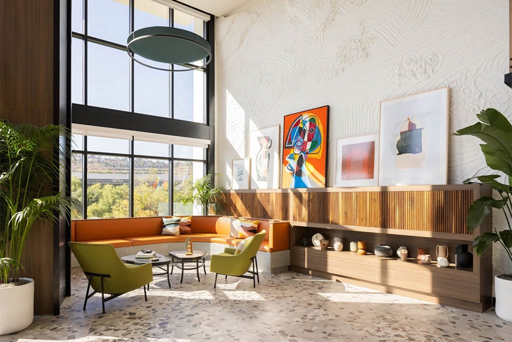 a rendering of a living room with orange couches and green chairs