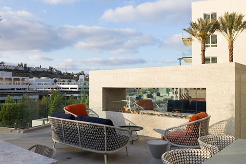 a terrace with wicker chairs and a table