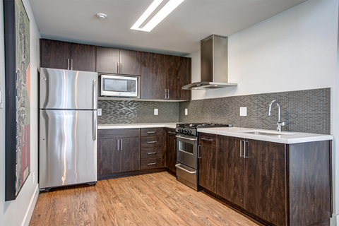 a kitchen with stainless steel appliances and wooden cabinets