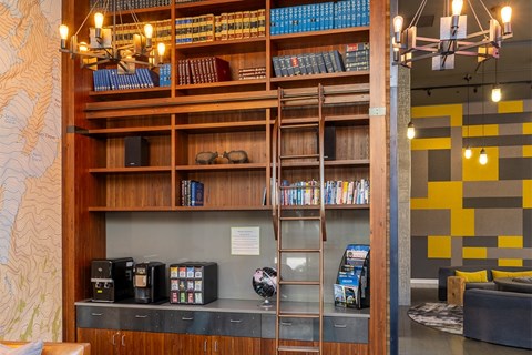 A room with a bookshelf and a ladder.
