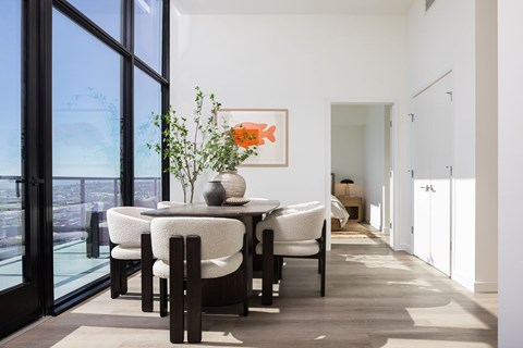 A dining room with a table set for four.