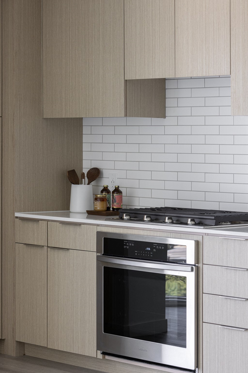 a kitchen with a stove and a microwave and cabinets