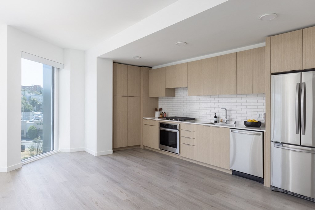 a kitchen with wooden cabinets and stainless steel appliances