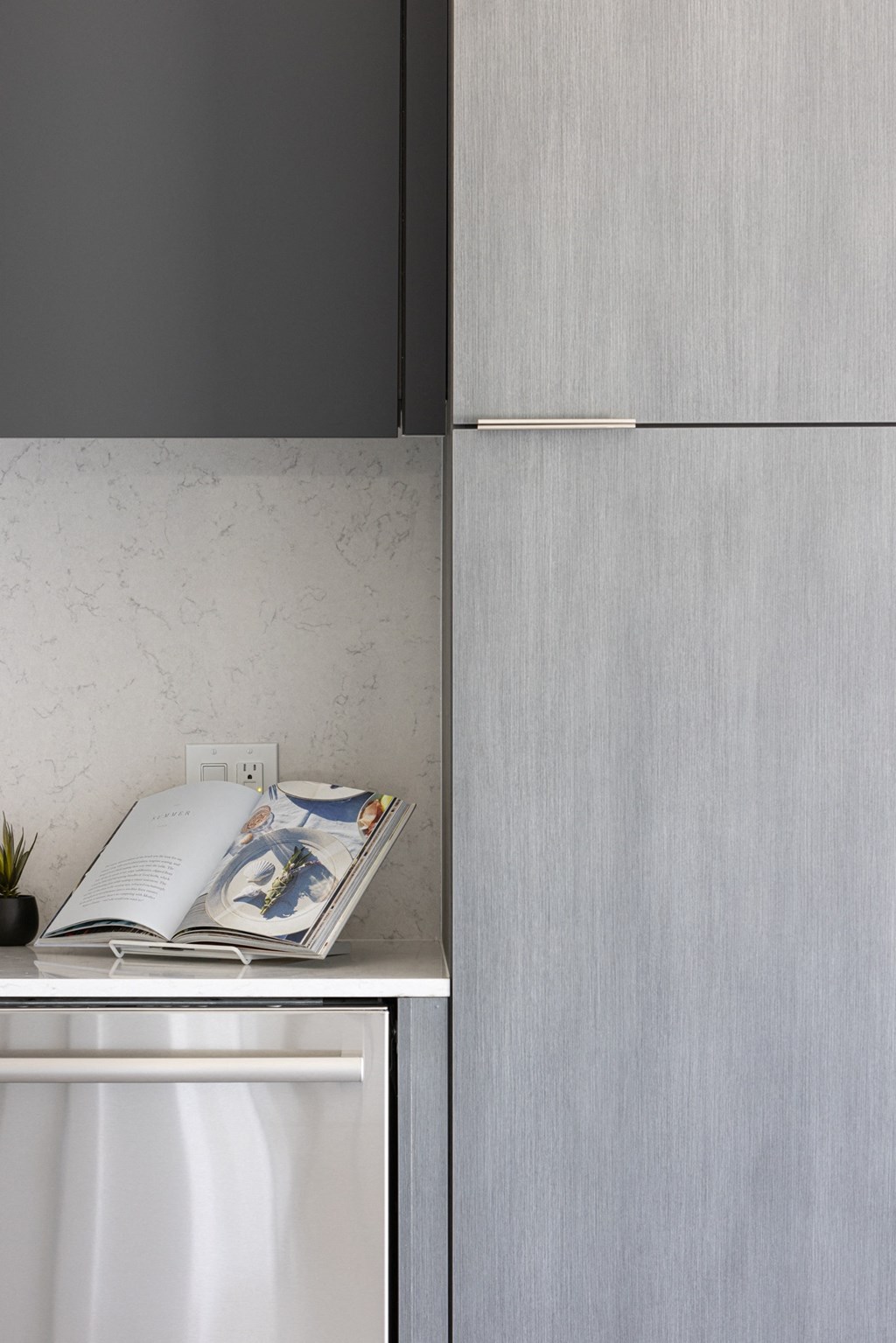 a kitchen with a white refrigerator and a book on the counter