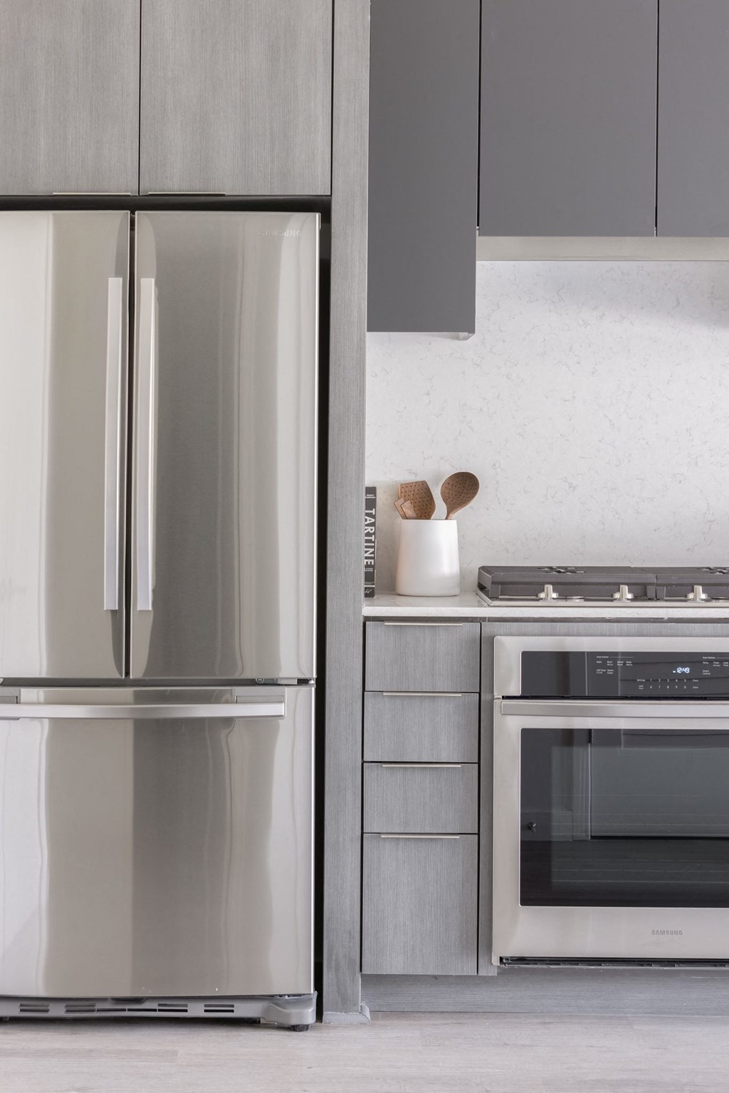 a kitchen with stainless steel appliances and a refrigerator