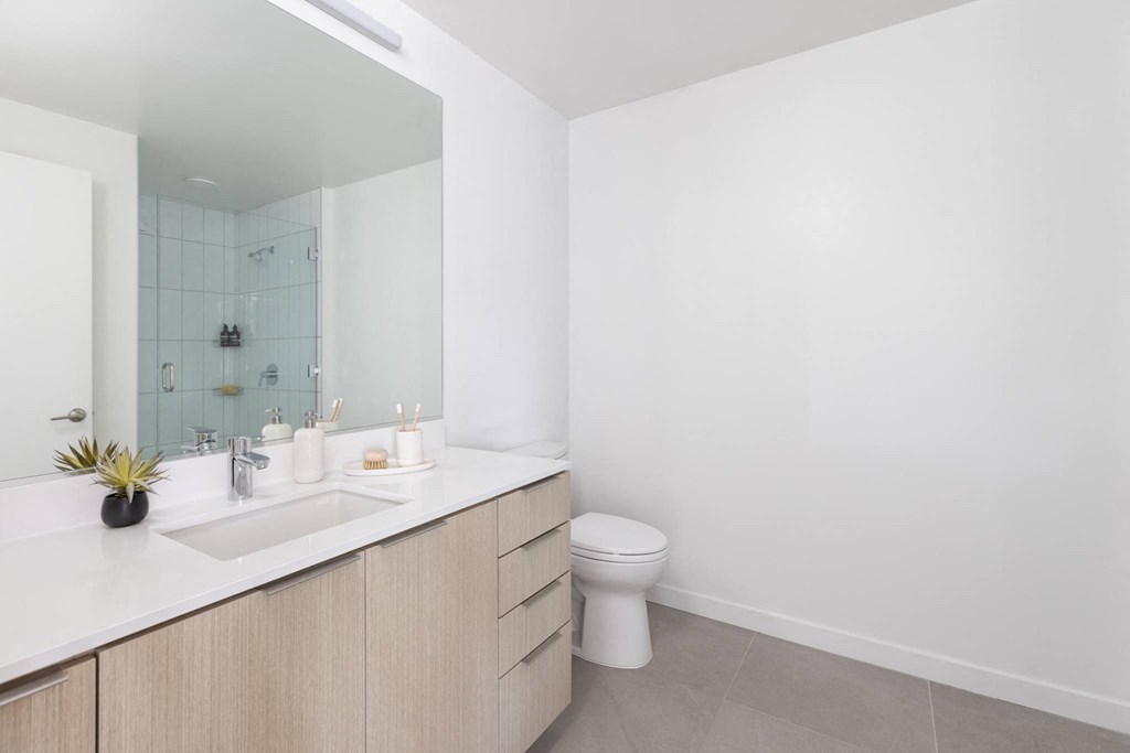 a bathroom with a toilet sink and a mirror