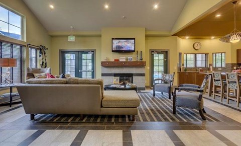 a living room with couches and chairs and a fireplace