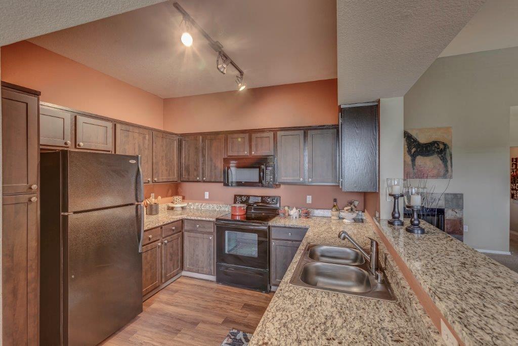 a kitchen with stainless steel appliances and granite counter tops