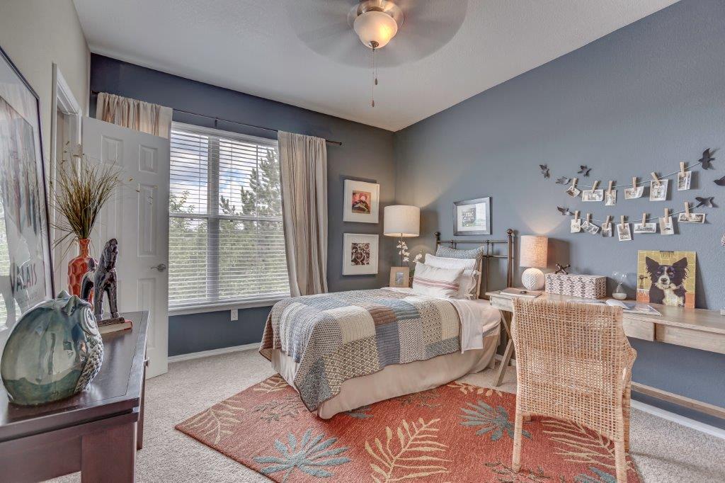 a bedroom with a bed and a desk