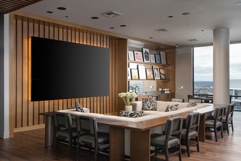A modern dining room with a long table and chairs.