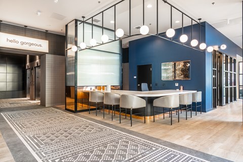 A modern dining area with a large table and chairs.