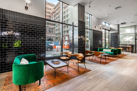 A living room with a green chair and a coffee table.