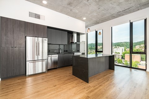 A modern kitchen with a large island and stainless steel appliances.