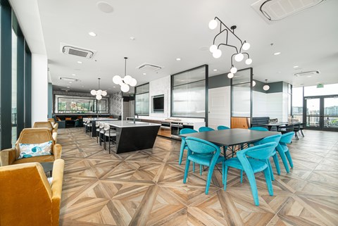 A modern dining room with a large table surrounded by chairs.